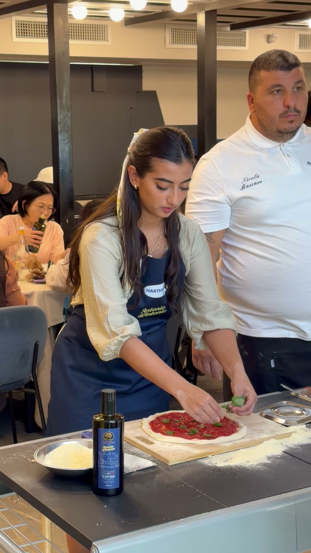Traveller from the first Riviera Cristallina Experience preparing pizza during a class in Naples